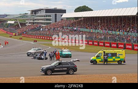 Formula 1 Grand Prix, Silverstone race accident ,July 2022, involving  Zhou Guanyu driver, with ambulance and packed grandstands Stock Photo
