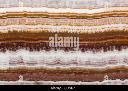 The structure of the variegated onyx with a natural crack. Stock Photo