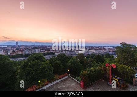 Turin, Italy. Panoramic view of the city in the evening after sunset. Skyline with the Mole in the evening. July 1, 2022. Stock Photo
