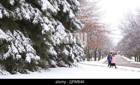 Toronto, Ontario / Canada - March 31, 2019: Mature healthy couple walking in winter, outside, healthy lifestyle. Stock Photo
