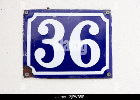 Number 36 (thirty six) in white on a blue metal plate Stock Photo