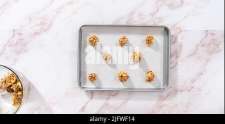 https://l450v.alamy.com/450v/2jfwf14/flat-lay-scooping-cookie-dough-into-the-baking-sheet-lined-with-parchment-paper-to-bake-apple-oatmeal-cookies-2jfwf14.jpg