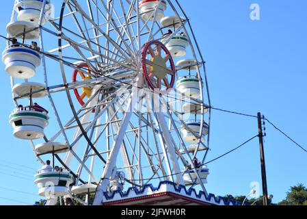 Tourists in an amusement park taking a ride on a Ferris wheel, Brazil, South America, Latin America Stock Photo