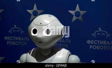 USA, New York - May 7, 2022: robot exhibition at the Russian Exhibition Center. HDR. Moving robot dancing, raising his hand and shaking head Stock Photo