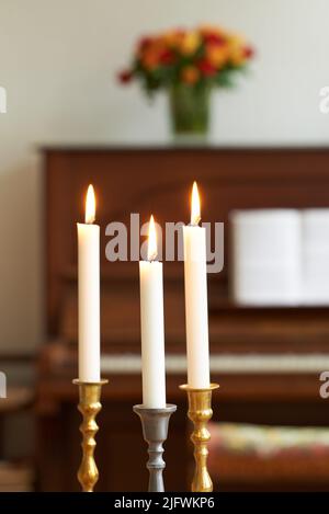 Pillar wax candle burning on white background Stock Photo - Alamy