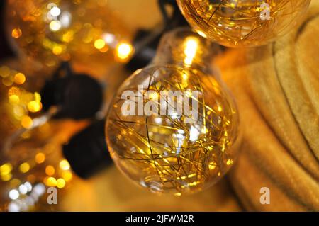 sparkling gold christmas garland with lights on the arm chair,decoration for holidays Stock Photo