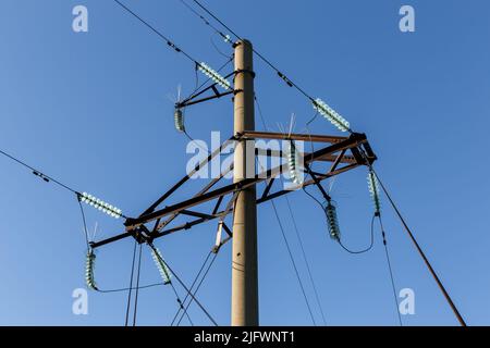 Concrete electricity pylon with glass insulators and bird spikes ...