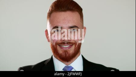 Handsome man feeling relief emotion portrait, redhead person wearing business suit Stock Photo