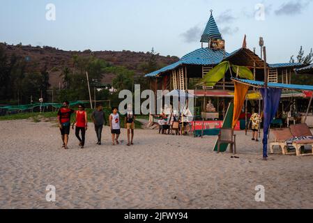 Mandrem Beach, Goa India May27 2022: Tourists and families relaxing and enjoying at Mandrem Beach in Goa India Stock Photo