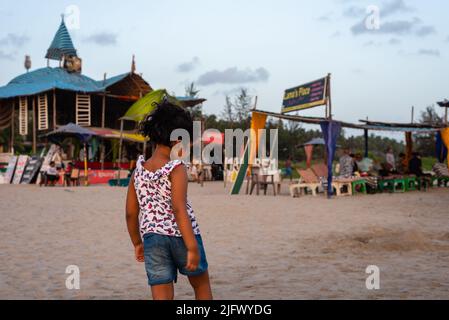 Mandrem Beach, Goa India May27 2022: Tourists and families relaxing and enjoying at Mandrem Beach in Goa India Stock Photo