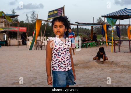 Mandrem Beach, Goa India May27 2022: Tourists and families relaxing and enjoying at Mandrem Beach in Goa India Stock Photo