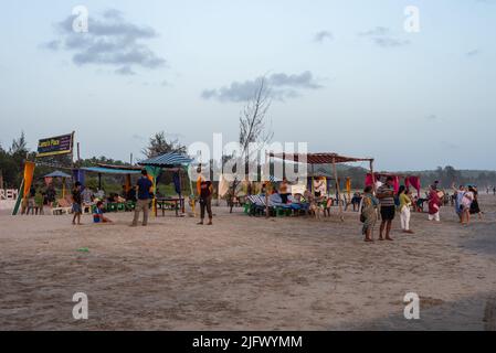 Mandrem Beach, Goa India May27 2022: Tourists and families relaxing and enjoying at Mandrem Beach in Goa India Stock Photo