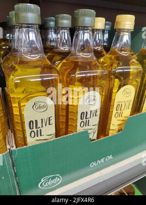 Olive oil bottles on a shelf at M&S Foodhall in the UK Stock Photo