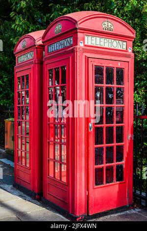 Symbol of Britain. Red telephone box. The red telephone box, a telephone kiosk for a public telephone designed by Sir Giles Gilbert Scott, is a famili Stock Photo