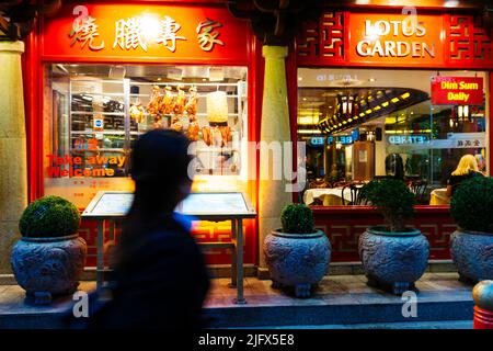 Showcase of a restaurant in Chinatown with crispy ducks hanging. Chinatown is an ethnic enclave in the City of Westminster. The enclave currently occu Stock Photo