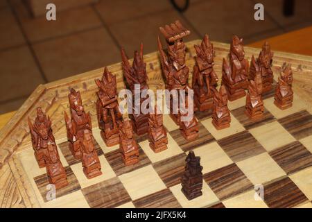 Old chess pieces carved in the Mayan style Stock Photo
