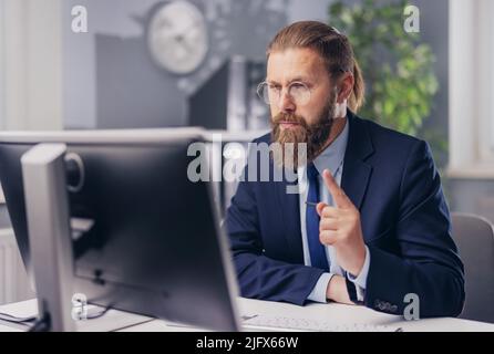 Focused man with pc at office Stock Photo