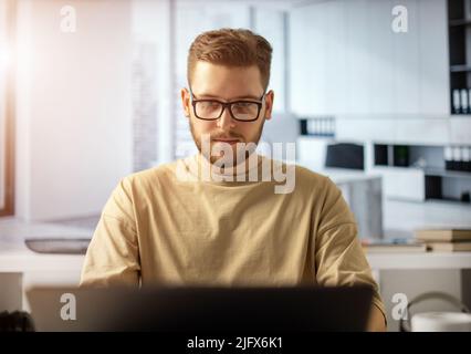 Man at office with laptop Stock Photo
