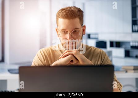 Man using laptop in office Stock Photo