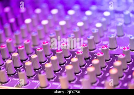 Close up detail of a music mixer control panel with rows if acoustic knobs for adjusting channels in an entertainment concept Stock Photo