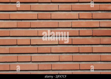 red brick wall seen from the outside with all its bricks aligned one on the other Stock Photo