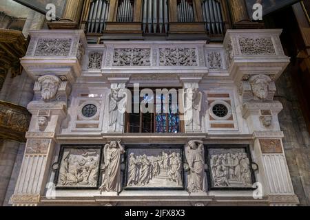 The stone decorations around the organ in the cathedral. Milan, Italy Stock Photo