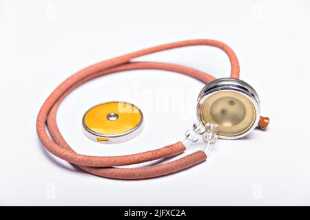 Old red stethoscope on isolated white background. Stock Photo