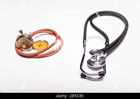Two old and one modern stethoscope on white background. Stock Photo