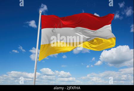official flag of red white yellow Austria at cloudy sky background on sunset, panoramic view. Austrian travel and patriot concept. copy space for wide Stock Photo