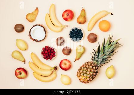 Various fruits on yellow background. Top view, flat lay. Tropical fruits, vegan food, healthy diet. Stock Photo
