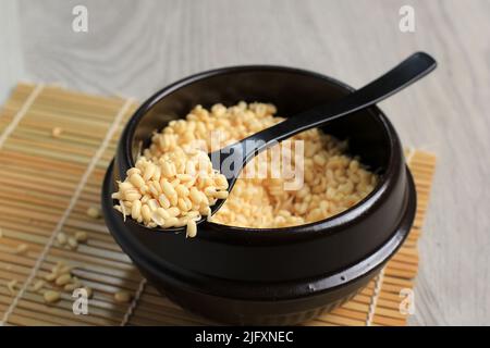 Organics fresh Baby Green Bean Sprouts in white ceramic bowl on old wood table top. Asian food ingredients. Stock Photo
