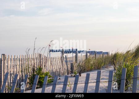 Rustic Picket fence lines the beautiful sand dunes of the ocean and beach of Cape May New Jersey Stock Photo