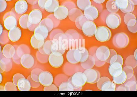 Background image with orange and white bokeh lights. Stock Photo