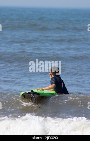 Surf lessons in Cape May New Jersey at the Cove in the ocean water with waves Stock Photo