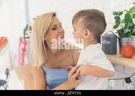 medium closeup view of the Caucasian mother with her little beloved son, motherhood concept. High quality photo Stock Photo