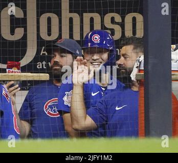 Milwaukee, Wisconsin. July 4, 2022, The Chicago Cubs' Seiya Suzuki (27)  slides safely home after hitting an inside-the-park home run in the ninth  inning of a baseball game against the Milwaukee Brewers