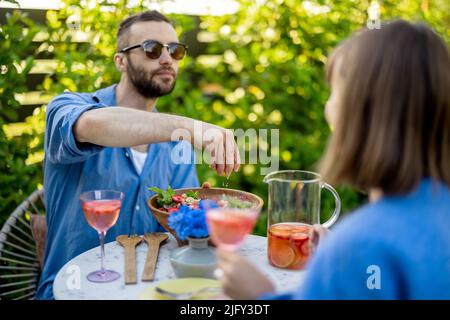 Young family having healthy lunch at backyard Stock Photo