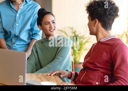 Multiracial male and female design professionals in discussing in creative office Stock Photo