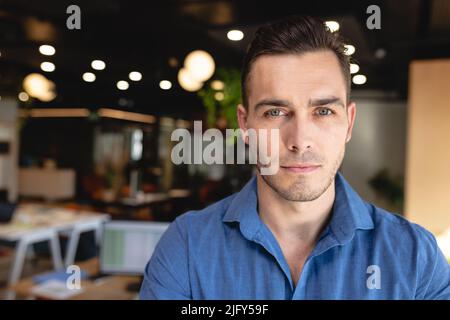 Portrait of confident young caucasian creative businessman in office Stock Photo