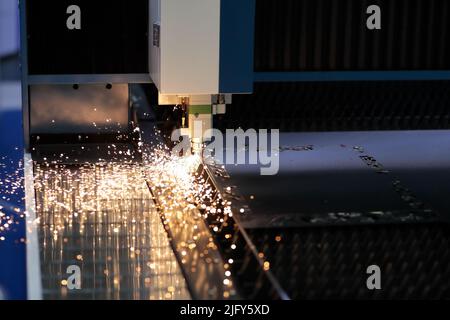 Metal sheet cutting process with CNC laser cutting machine. Selective focus. Stock Photo