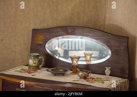 Oval mirror with brown wooden frame at Amuri Museum of historic Housing in Tampere Finland Stock Photo