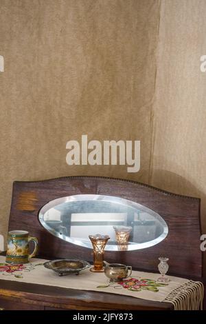 Oval mirror with brown wooden frame at Amuri Museum of historic Housing in Tampere Finland Stock Photo