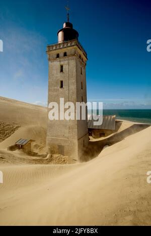 The Lighthouse at Rubjerg Knude is partly buried in the sand.  A few years before this picture was taken in August 2005, houses and other building wer Stock Photo