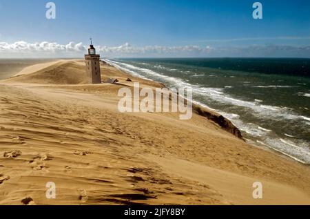 The Lighthouse at Rubjerg Knude is partly buried in the sand.  A few years before this picture was taken in August 2005, houses and other building wer Stock Photo