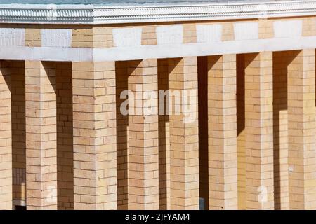 The rhythmic pattern created by the alternation of light and shadow on the columns of the building Stock Photo