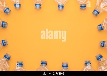 Top view old clear plastic water bottle on yellow background Stock Photo