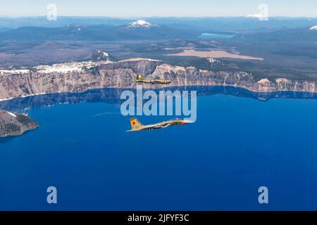 Klamath Falls, Oregon, USA. 24th June, 2022. A U.S. Air Force F-15 Eagle from the 173rd Fighter Wing bearing a paint scheme commemorating Kingsley Field's namesake, Lt. David R. Kingsley, flies in formation with a WWII-era B-17 Flying Fortress over Crater Lake, Ore. during Sentry Eagle 2022, June 24. Kingsley was a bombardier on a B-17 during the war and sacrificed his life to save another crew members and was subsequently awarded the Medal of Honor. Credit: U.S. National Guard/ZUMA Press Wire Service/ZUMAPRESS.com/Alamy Live News Stock Photo