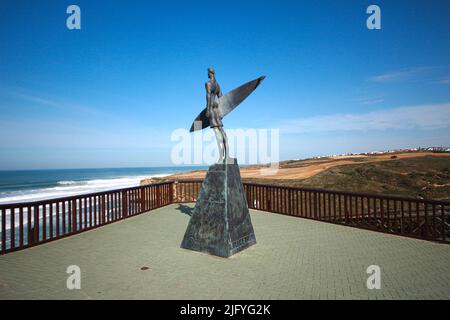 Statue of a surfer in the beach of Ribeira dIlhas World Surf Reserve. Ericeira in Portugal. Stock Photo