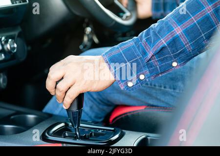Car driving concept : Close up driver hand on automatic gear stick inside the modern car Stock Photo