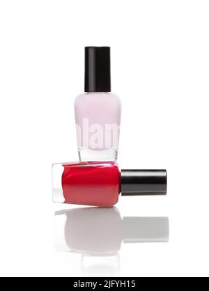 Two bottles of nail polish arranged in a funny balance against white background and a soft shadow Stock Photo